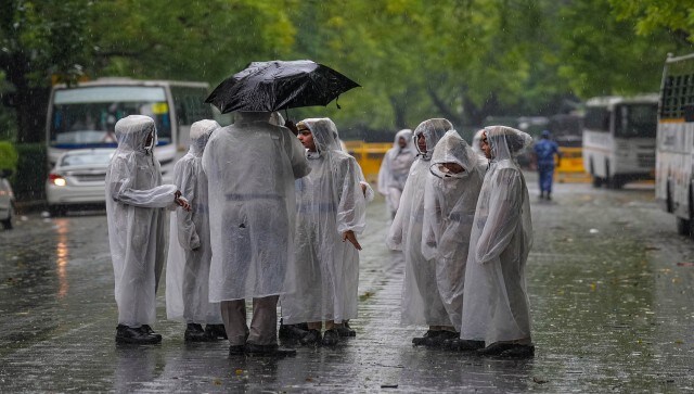 Security personnel patrol during rain, in New Delhi. On Friday, the maximum temperature in Delhi settled at 34.5 degrees Celsius, five notches below normal. PTI