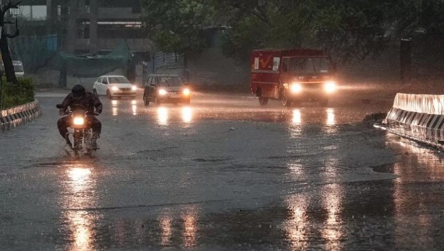 A vehicle moves through a waterlogged road during rain, in New Delhi. Commuters took to Twitter to complain about traffic jams. Major jam building on the flyover from Vasant Vihar to the airport, a person posted on the social media platform. PTI