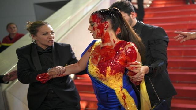 The woman draped in the Ukrainian flag colours was quickly jumped on by officials and escorted away. Identified as Ilona Chernobai, she told her one million Instagram followers, “I succeeded in fulfilling my mission. I took my chance with this act and reminded what is happening in Ukraine.” AP The woman draped in the Ukrainian flag colours was quickly jumped on by officials and escorted away. Identified as Ilona Chernobai, she told her one million Instagram followers, “I succeeded in fulfilling my mission. I took my chance with this act and reminded what is happening in Ukraine.” AP