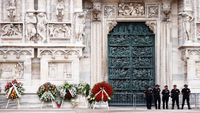 Security personnel stand near the garlands for the funeral of PM Berlusconi, in front of the Duomo Cathedral, in Milan. Berlusconi died at the age of 86 on Monday in a Milan hospital while being treated for chronic leukaemia. His family held a private wake Tuesday at one of his villas near Milan, the city where he made his billions as the head of a media empire before entering politics in 1994. Reuters