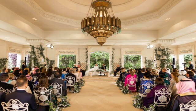 Jordan’s Crown Prince Hussein and Rajwa Alseif sit during the wedding ceremony in Amman, Jordan. The families and their guests gathered in an open-air gazebo decked with flowers and surrounded by landscaped gardens for a traditional Muslim wedding ceremony known as “katb al-ketab.” AP