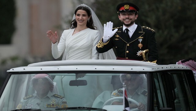 Jordan’s Crown Prince Hussein and Saudi Rajwa Alseif wave to well-wishers during their wedding ceremonies in Amman, Jordan. The crowd erupted in applause after the signing of the marriage contract. Alseif will henceforth be known as Her Royal Highness Princess Rajwa Al Hussein, according to a royal decree. AP