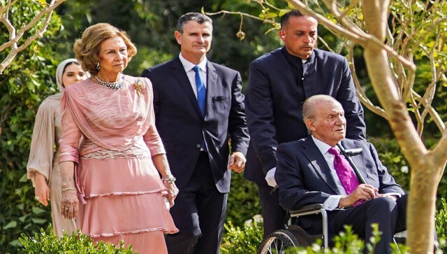 Former King of Spain Juan Carlos, in a wheelchair, and his wife Sofia arrive at the marriage ceremony of Crown Prince Hussein and Saudi architect Rajwa Alseif. AP