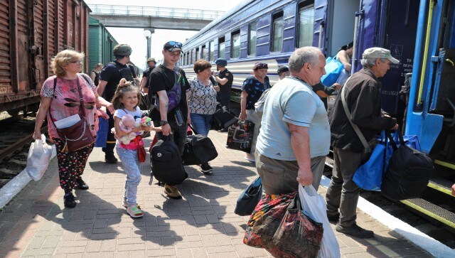 People board an evacuation train at a railway station in Kherson, Ukraine. Officials said about 22,000 people live in areas at risk of flooding in Russian-controlled areas on the eastern side of the river, while 16,000 live in the most critical zone in Ukrainian-held territory on the western side — areas like those evacuated on Tuesday. AP