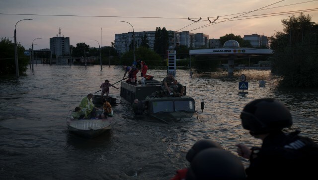 Residents are evacuated from a flooded neighbourhood in Kherson, Ukraine. Dozens of evacuees on the island scurried onto the tops of military trucks or into rafts to flee rising floodwaters caused by a dam breach upstream. AP