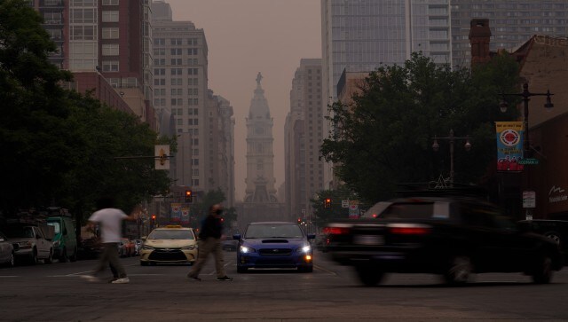 Evening commuters travel on Broad Street past a hazy City Hall, Wednesday, in Philadelphia. In suburban Philadelphia, officials set up an emergency shelter so people living outside can take refuge from the haze. AP Evening commuters travel on Broad Street past a hazy City Hall, Wednesday, in Philadelphia. In suburban Philadelphia, officials set up an emergency shelter so people living outside can take refuge from the haze. AP