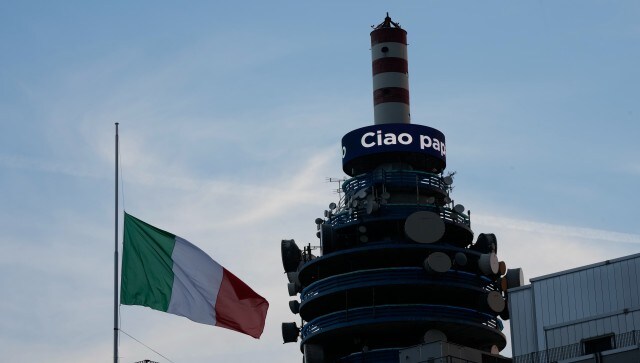 A half-mast Italian flag flatters in front of a message reading Ciao Papa’ (Bye Dad) on a tower of the Mediaset media conglomerate headquarters. Most Italians identify Berlusconi, a media mogul, soccer entrepreneur and three-time former premier, as the most influential figure in Italy over recent decades. AP