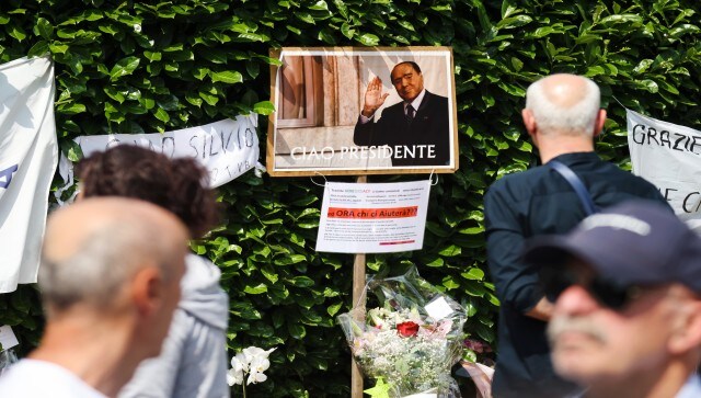 People gather outside former Italian premier Berlusconi’s residence, in Arcore, near Milan, Italy. But they remain sharply divided on whether his influence was for the better or worse. They are split over whether the three-time former premier merits all the fuss and ceremony. AP