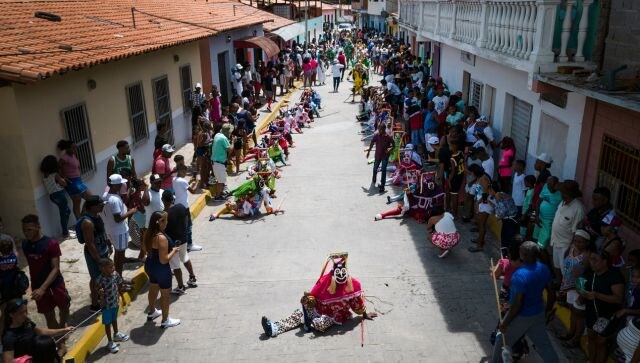 In Naiguata, devils don multi-coloured costumes and masks of usually sea creatures and other mythological figures as they dance on the streets. Believers carry maracas, bells, handkerchiefs and strips of ribbon to stave off evil spirits. AP