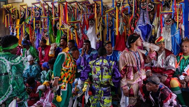 As per Euronews, the festival of the Dancing Devils, which is celebrated in 11 confraternities across Venezuela, dates back more than 200 years. It largely takes from indigenous, Spanish and African cultures. Those participating in the festival dress as devils, wear outrageous masks and dance backward in penitence as an official of the Catholic Church holds the Blessed Sacrament. AP