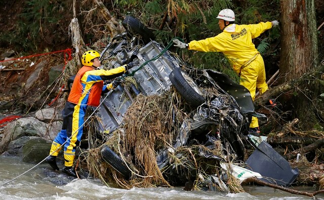 Rescuers in Japan worked into a third day on Tuesday in a search for survivors. The typhoon is said to have killed nearly 70 people and caused widespread destruction. AP Rescuers in Japan worked into a third day on Tuesday in a search for survivors. The typhoon is said to have killed nearly 70 people and caused widespread destruction. AP