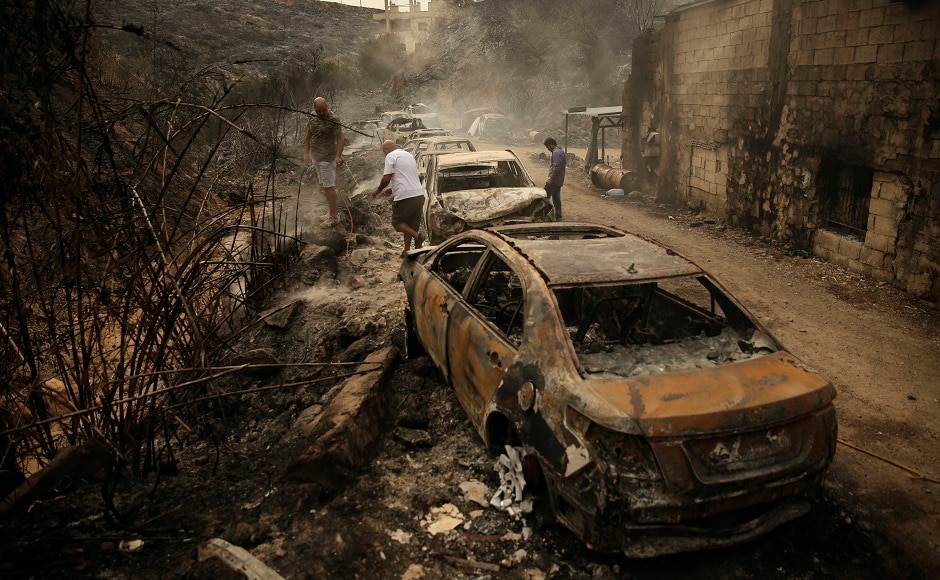 In Damour, a coastal village south of Beirut, more than a dozen charred cars were on the side of a road. Most of the homes nearby escaped the damage. AP In Damour, a coastal village south of Beirut, more than a dozen charred cars were on the side of a road. Most of the homes nearby escaped the damage. AP