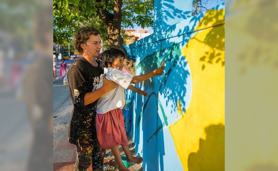 A wide array of curated workshops with artists and local organisations, facilitated by volunteers from SPI Edge, will include activities ranging from collage making to photography to spray painting to hand-lettering for kids and adults. Australian street artist Bronte Naylor (as shown above), conducted painting workshops with the young residents of Kannagi Nagar. While lifting up kids who found it tricky to reach the upper corners of the wall, Naylor guided the others on which combinations of colours they could use to give the mural a defining look. A wide array of curated workshops with artists and local organisations, facilitated by volunteers from SPI Edge, will include activities ranging from collage making to photography to spray painting to hand-lettering for kids and adults. Australian street artist Bronte Naylor (as shown above), conducted painting workshops with the young residents of Kannagi Nagar. While lifting up kids who found it tricky to reach the upper corners of the wall, Naylor guided the others on which combinations of colours they could use to give the mural a defining look.