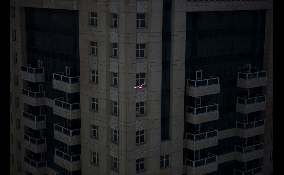 A fundraising initiative, titled 'For the Love of Beirut', is led by Ruwa and Gulf Photo Plus in partnership with Beirut Center of Photography, In My House, and Jadaliyya to celebrate love and an intimate appreciation for the city, and to support the communities affected by the blast | Photograph by Natalie Naccache. In the picture: Free. A pink coloured pigeon flies between buildings in Doha, Qatar | (2014) A fundraising initiative, titled 'For the Love of Beirut', is led by Ruwa and Gulf Photo Plus in partnership with Beirut Center of Photography, In My House, and Jadaliyya to celebrate love and an intimate appreciation for the city, and to support the communities affected by the blast | Photograph by Natalie Naccache. In the picture: Free. A pink coloured pigeon flies between buildings in Doha, Qatar | (2014)
