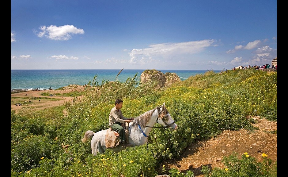 These photographs have been put up for print sale, of which 100 percent of the proceeds (minus printing/packaging costs) will be donated to the Lebanese Red Cross | Photograph by Stephanie Sinclair. In the picture: A young boy rides a horse along the Corniche, a walkway along the Mediterranean Sea, Beirut, Lebanon. Several horses are available for short rides near the water, a common leisure activity for less wealthy residents of Beirut | (2006) These photographs have been put up for print sale, of which 100 percent of the proceeds (minus printing/packaging costs) will be donated to the Lebanese Red Cross | Photograph by Stephanie Sinclair. In the picture: A young boy rides a horse along the Corniche, a walkway along the Mediterranean Sea, Beirut, Lebanon. Several horses are available for short rides near the water, a common leisure activity for less wealthy residents of Beirut | (2006)