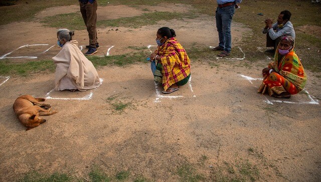 Voters were found wearing masks and maintaining social distance as they stood inside the rings drawn at six feet distance outside the polling stations. AP