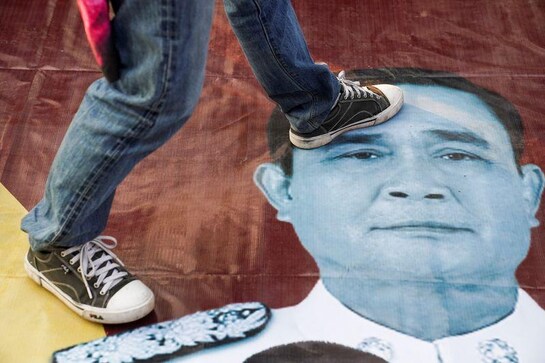 Thai protests outside parliament after PM survives vote Thai protests outside parliament after PM survives vote