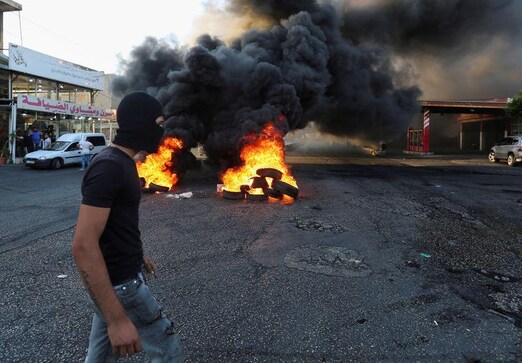 Lebanon protesters burn roads, clash with security in second night of unrest Lebanon protesters burn roads, clash with security in second night of unrest