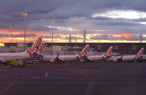 Virgin Australia to merge units, cut jobs as it swings to FY loss Virgin Australia to merge units, cut jobs as it swings to FY loss