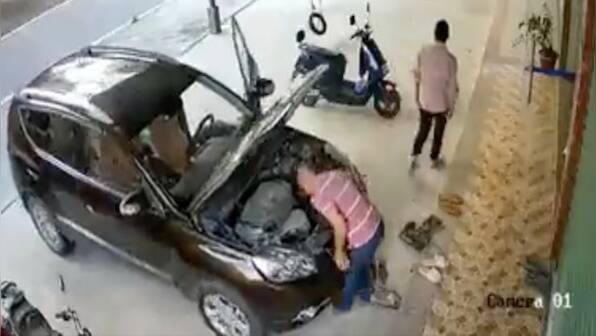 Watch: Man gets smashed by parked car while fixing it, video shivers ...