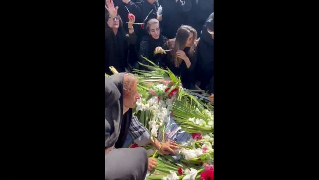 Watch: Woman chops hair at brother's funeral who was killed in Iran protests Watch: Woman chops hair at brother's funeral who was killed in Iran protests