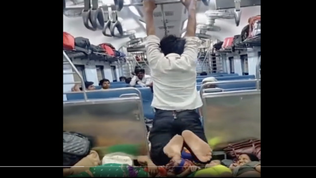 Watch: Man swings like Spiderman inside train, internet left amazed Watch: Man swings like Spiderman inside train, internet left amazed