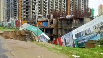 Noida: Part of main road, construction site caves in due to heavy downpour in Noida; no casualty