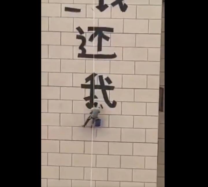 Where’s my money: A Chinese worker hangs mid-air to paint protest on skyscraper for unpaid wages