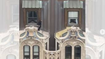 Watch: Man wearing suit jumps across window awnings of 23-storey New York building