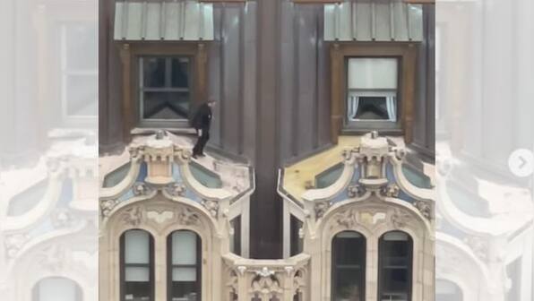 Watch: Man wearing suit jumps across window awnings of 23-storey New York building