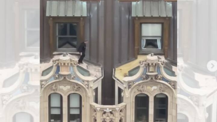 Watch: Man wearing suit jumps across window awnings of 23-storey New York building