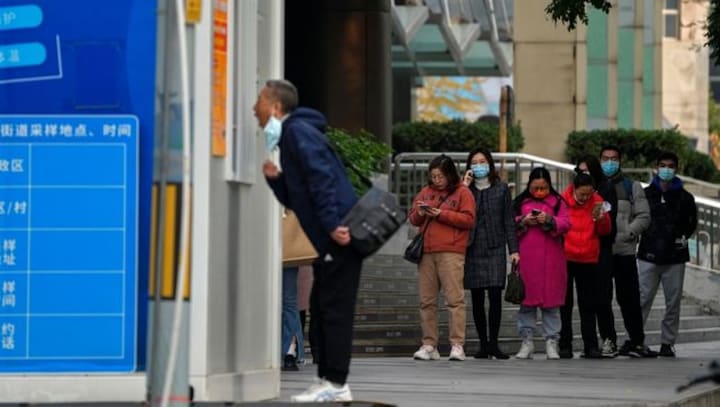 As workers flee biggest iPhone factory in China, authorities clamp COVID lockdown in whole area around Foxconn