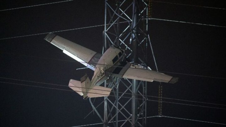 Crews work to rescue two in single-engine plane caught high in live power lines