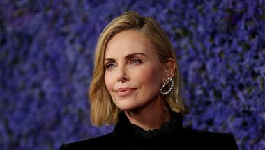 'Women are tearing down the whole … building,' says Charlize Theron after being honored at Women in Entertainment gala