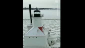 Watch: Lighthouse and surrounding pier in Lake Michigan shrouded in ice following blizzard