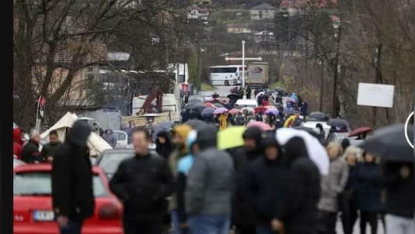Tensions run high in north Kosovo with Serbs blocking roads as shots, explosions rang out