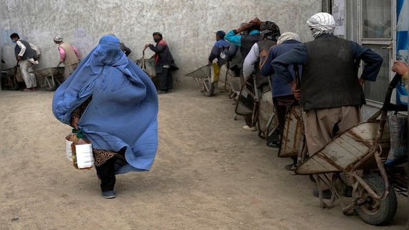 WATCH: Taliban surround a woman in a pit and stone her