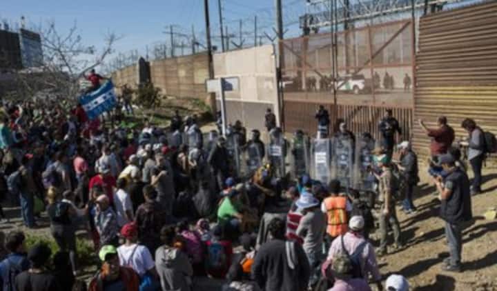 Hundreds of migrants attempt to storm the US-Mexico border