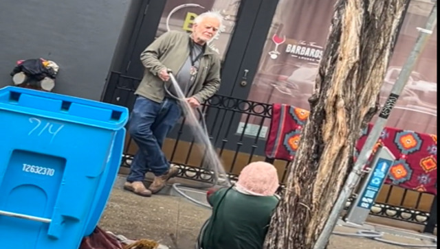 US man sprays water on homeless woman to ward her off the street; internet is angry with his actions US man sprays water on homeless woman to ward her off the street; internet is angry with his actions
