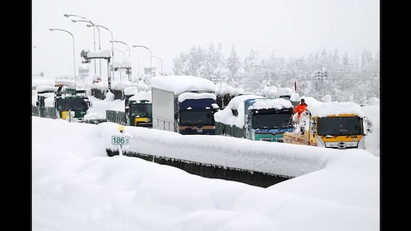 Heavy snow in Japan disrupts flights and trains, closes roads