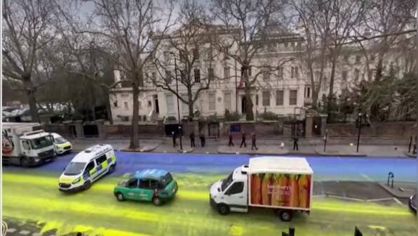 Demonstrators paint huge Ukrainian flag outside Russian embassy in London