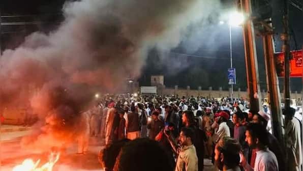 Imran Khan's party workers clash with police outside his Lahore residence to foil his arrest