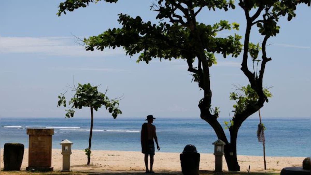 Officials deport Russian tourist for posting half-naked photo on sacred peak in Bali