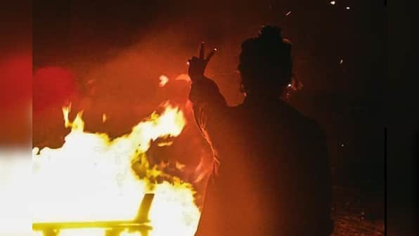Iran protesters return to streets during fire festival, burn hijabs & Khamenei's posters
