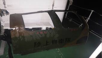 Army finds door, unused lifeboat in search for lost Japanse army helicopter