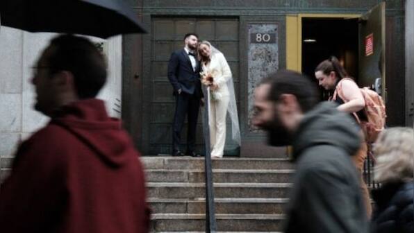 Captive audience: Couples marry in shadow of Donald Trump's arraignment at New York courthouse