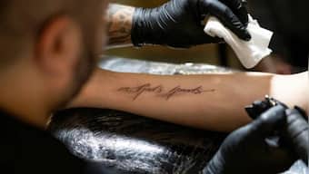 'In god's hands': Catholics assemble in numbers at Austrian church for 'free' tattoo