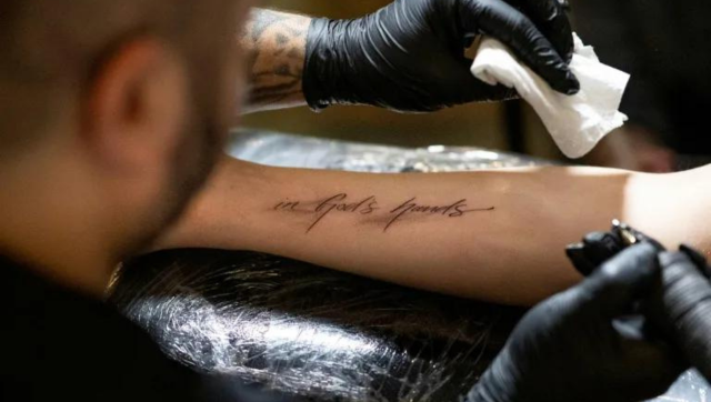'In god's hands': Catholics assemble in numbers at Austrian church for 'free' tattoo 'In god's hands': Catholics assemble in numbers at Austrian church for 'free' tattoo