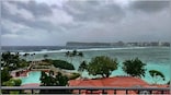 Rain, winds lash Guam as Typhoon Mawar closes in and residents shelter
