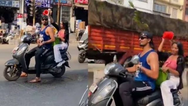 WATCH | Maharashtra couple bathe on a moving scooter, police swing into action after netizens protest WATCH | Maharashtra couple bathe on a moving scooter, police swing into action after netizens protest
